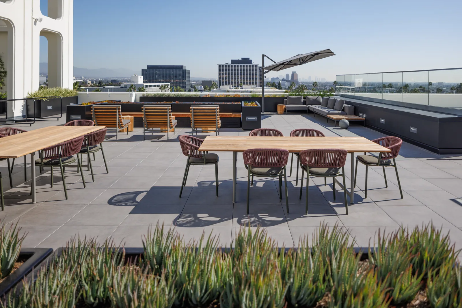 Dining and lounge seating on the terrace with the Los Angeles skyline
