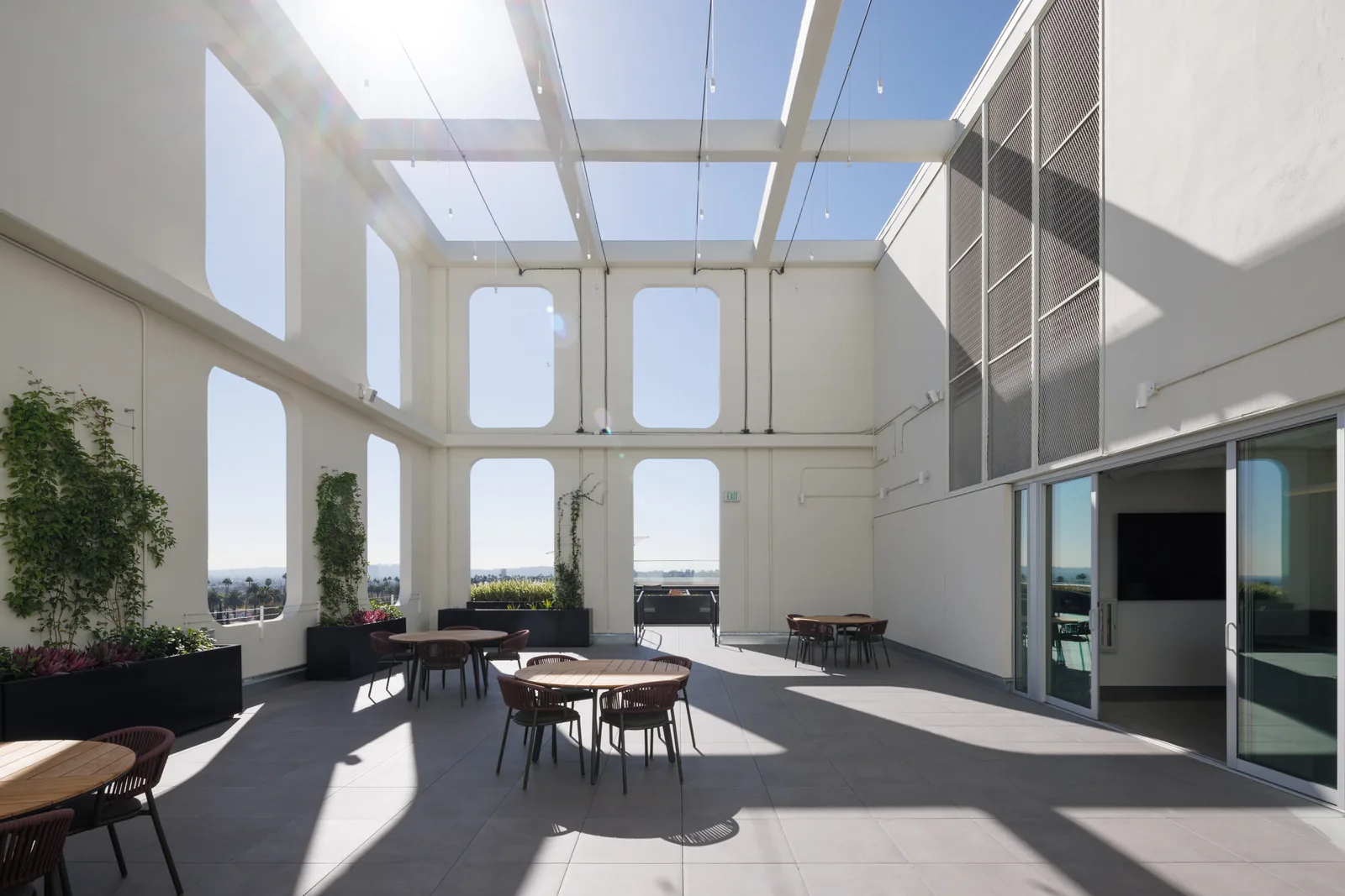 Sunlit rooftop terrace with tables and chairs