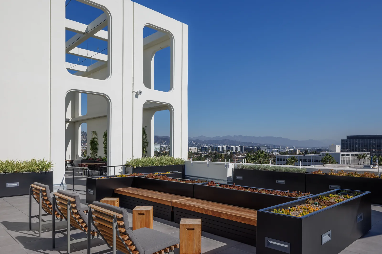 Lounge with sculptural porthole walls, benches and mountain views