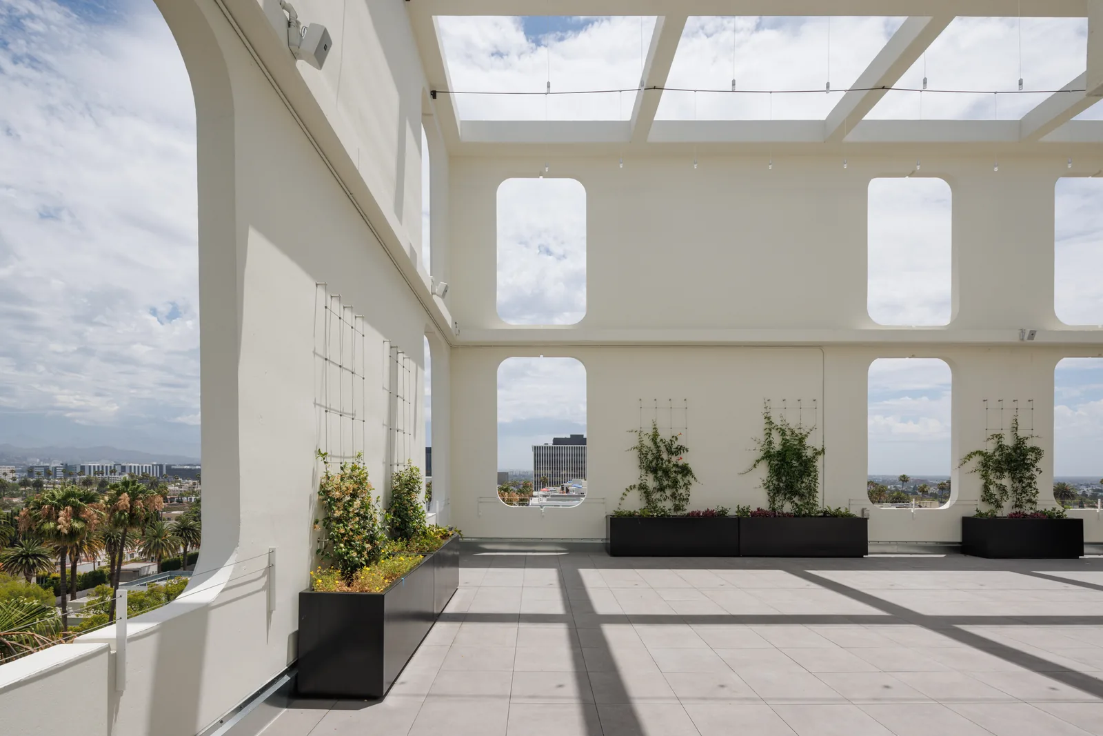 Double-height porthole openings framing the sky