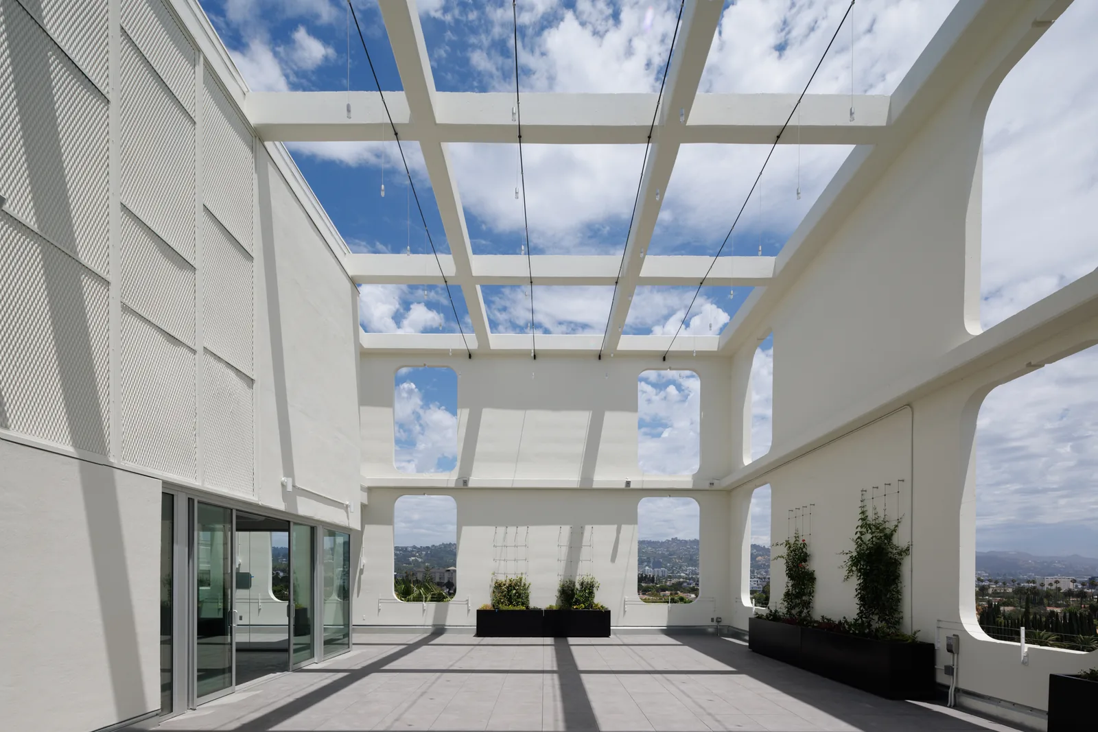 Bright open-air terrace with views toward the hills