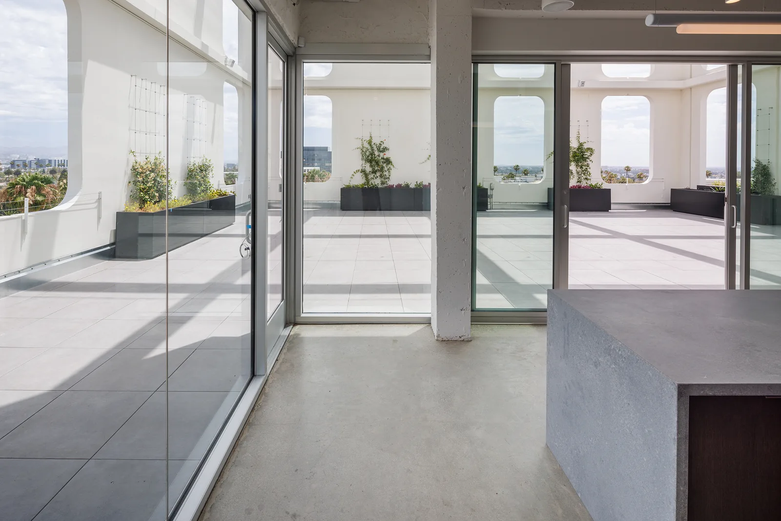 Sliding glass doors connecting the indoor room to the terrace
